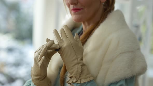 Unrecognizable Rich Elegant Middle Aged Woman Putting on Expensive Luxurious Ring on Glove Smiling