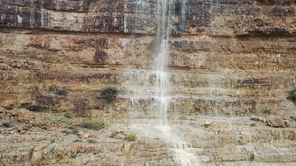 Israel, desert waterfall after rain, flood water, drone fly down shot