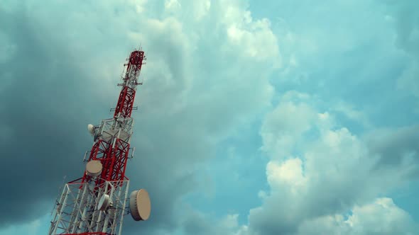 Large Telecommunication Tower Against Sky and Clouds in Background