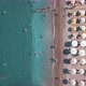 Aerial Top View of Beach with Sunshade and People Swimming at Beautiful Blue Color Sea - VideoHive Item for Sale