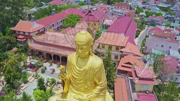 Golden Buddha Sculpture Face Against Temple Complex