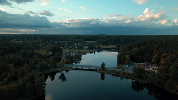 Phenomenal drone aerial of amazing Reflective River through small village of Kowalskie Blota