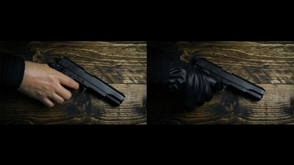 Gun Picked Up By Hand And Gloved Hand