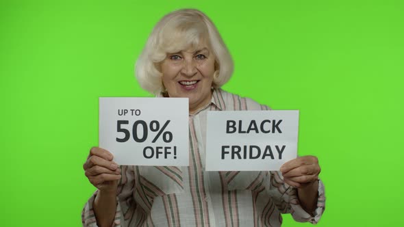 Grandmother Showing Black Friday and Up To 50 Percent Off Shopping Price Discount Advertisement
