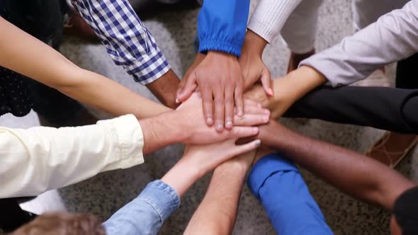 Hands of business team stacking their hands together