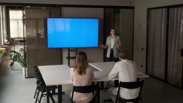 Diverse office conference room meeting female project manager use Chroma Key wall mounted