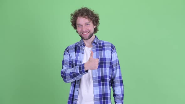 Happy Young Bearded Hipster Man Giving Thumbs Up