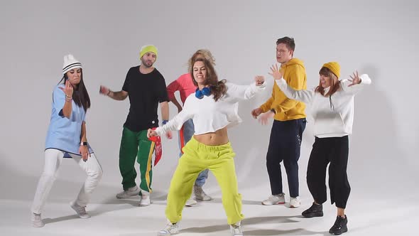 Group of Happy Young People Dancing Cheerfully on Stage of Dance School Studio.