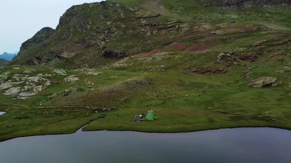 Aerial view of some campers near a mountain lake in summer