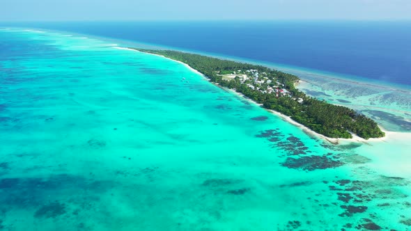 Natural birds eye travel shot of a sunshine white sandy paradise beach and aqua blue water backgroun