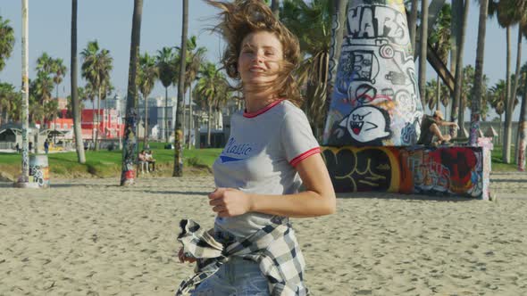 Happy girl running in Venice Beach