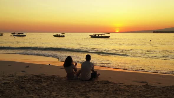 Guy and girl sunbathing on paradise bay beach lifestyle by transparent sea and clean sandy backgroun