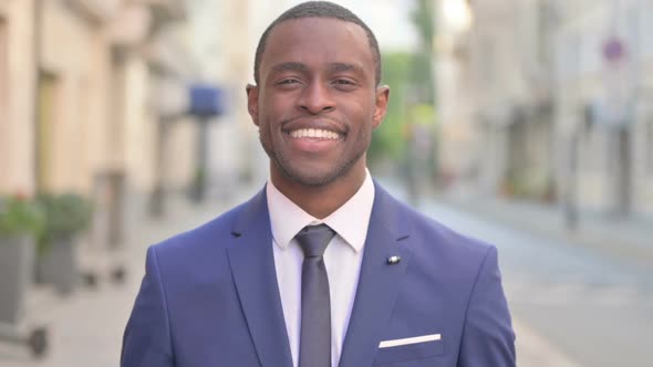 Outdoor Happy African Businessman Smiling Toward the Camera