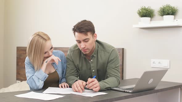 Married Couple Use Laptop at Home While Home Audit