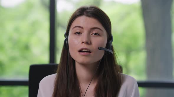 Smiling Beautiful Caucasian Woman in Earphones Talking Looking at Camera in Video Chat