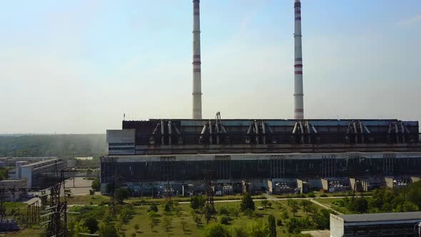 Industrial Chimneys With Smoke. Air pollution by smoke coming out of two factory chimneys