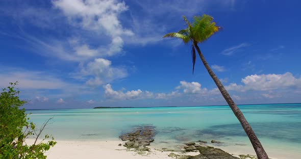 Wide aerial abstract shot of a white paradise beach and aqua blue ocean background in 4K