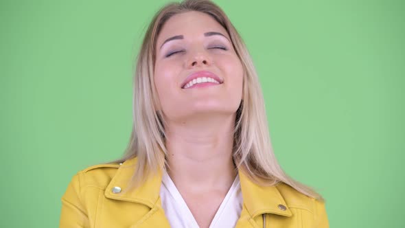 Face of Happy Young Rebellious Blonde Woman Relaxing with Eyes Closed