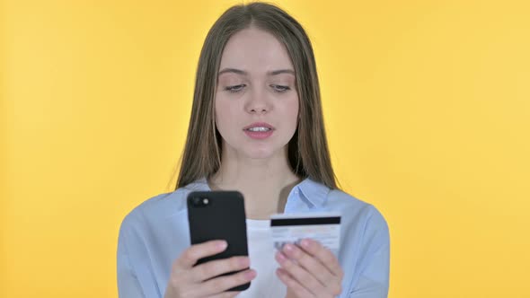 Online Payment on Smartphone By Young Woman, Yellow Background