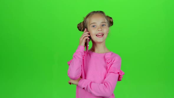 Baby Is Talking on the Phone with Her Mom. Green Screen. Slow Motion