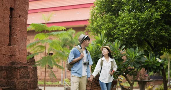 Couple hand together while visiting at ancient temple