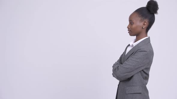 Profile View of Young Happy African Businesswoman with Arms Crossed