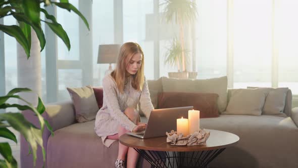 Woman Sitting on Couch and Using Laptop for Video Call