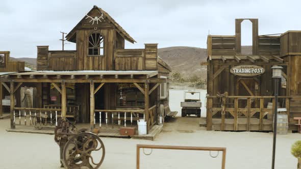 Flying through main street of an old wooden westernie set in the middle of the desert