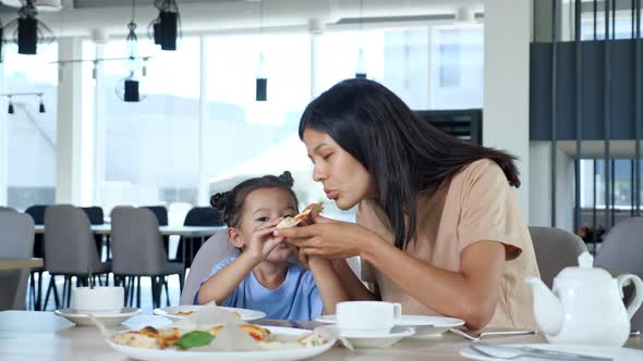 Asian Woman Mom and Toddler Girl Eat Delicious Snack