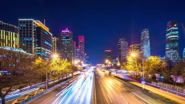 Timelapse of busy traffic road with modern office building in beijing china