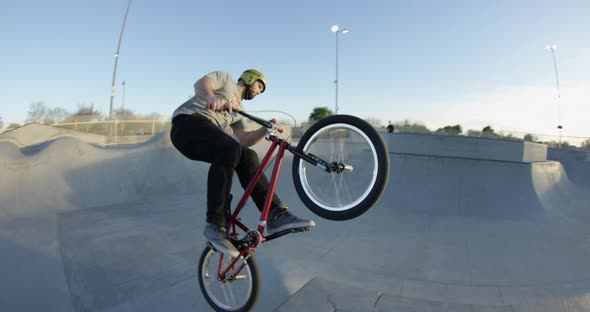 BMX rider doing tricks in skatepark