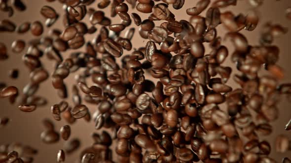 Super Slow Motion Shot of Crashing Coffee Beans on Brown Gradient Background at 1000Fps