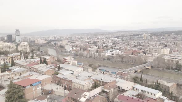 Aerial View of Galaktion Tabidze Bridge over Kura river in the centre of Tbilisi. Georgia 2021 April