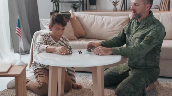Boy and Father Playing with Toy Soldiers