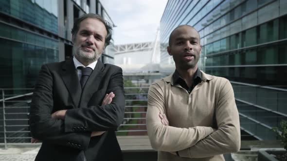 Happy Male Business Colleagues Standing Outdoors