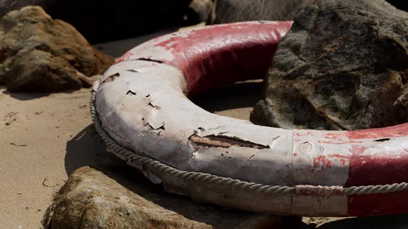 Old Broken Lifebuoy on Sea Beach