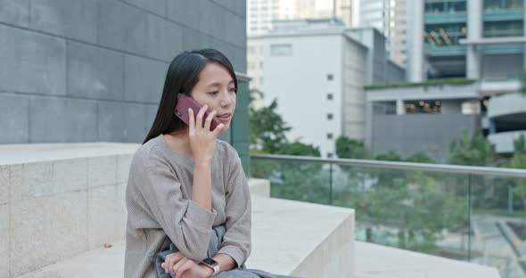 Woman talk to cellphone in the city