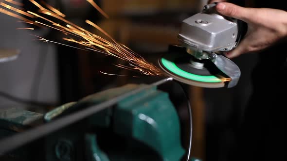 Woman Grinding Iron Pipe Using Grinder