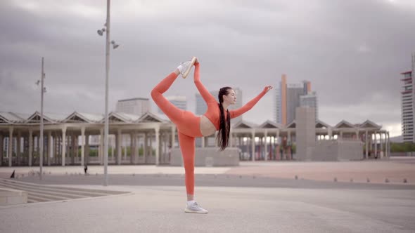 Female Athlete Stretching in the City Before Running