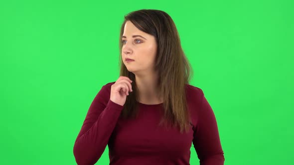 Portrait of Pretty Girl Is Scared, Then Smiles and Sighs in Relief. Green Screen