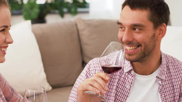 Happy Couple Drinking Red Wine at Home