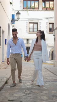 Stylish Hispanic Couple Speaking While Walking in Town