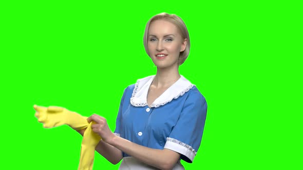 Woman Cleaner Puts on Rubber Gloves