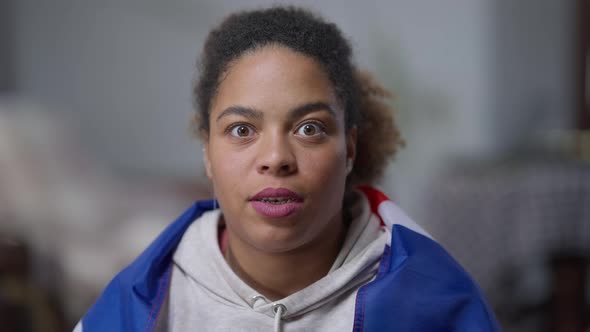 Face of Excited African American Woman Cheering for Sports Team Making Victory Gesture