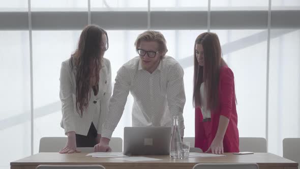 Handsome Successful Confident Bearded Businessman Sharing Ideas with His Colleagues or Subordinates