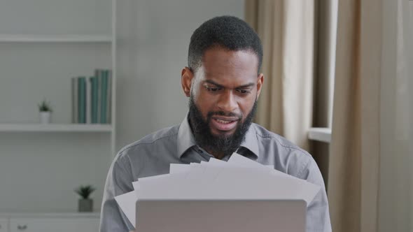 Overworked Millennial Black Male Office Worker Stressed By Paperwork