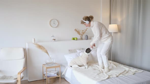 Happy Family And Pregnancy Concept. Pregnant Woman Playing With Dog At Home