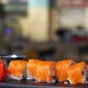 Salmon roll sushi with cheese. Tasty sushi with salmon on top. Set of japanese food on black tray. - VideoHive Item for Sale