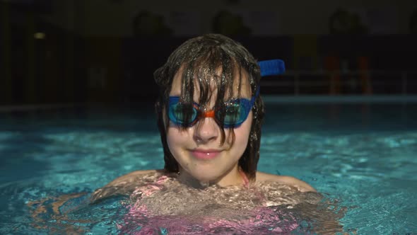 Portrait of a Teenage Girl with Glasses for Swimming Come Up From Pool Water.