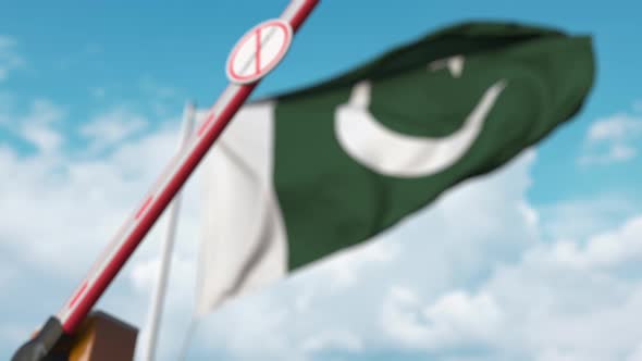 Barrier Gate with STOP CORONAVIRUS Sign Being Closed at Flag of Pakistan alt